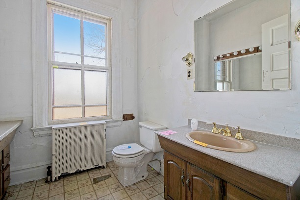 26 MacArthur Loop Highland Park, IL 60035 - Photo 16 of 47 a bathroom with a granite countertop sink toilet a mirror and window