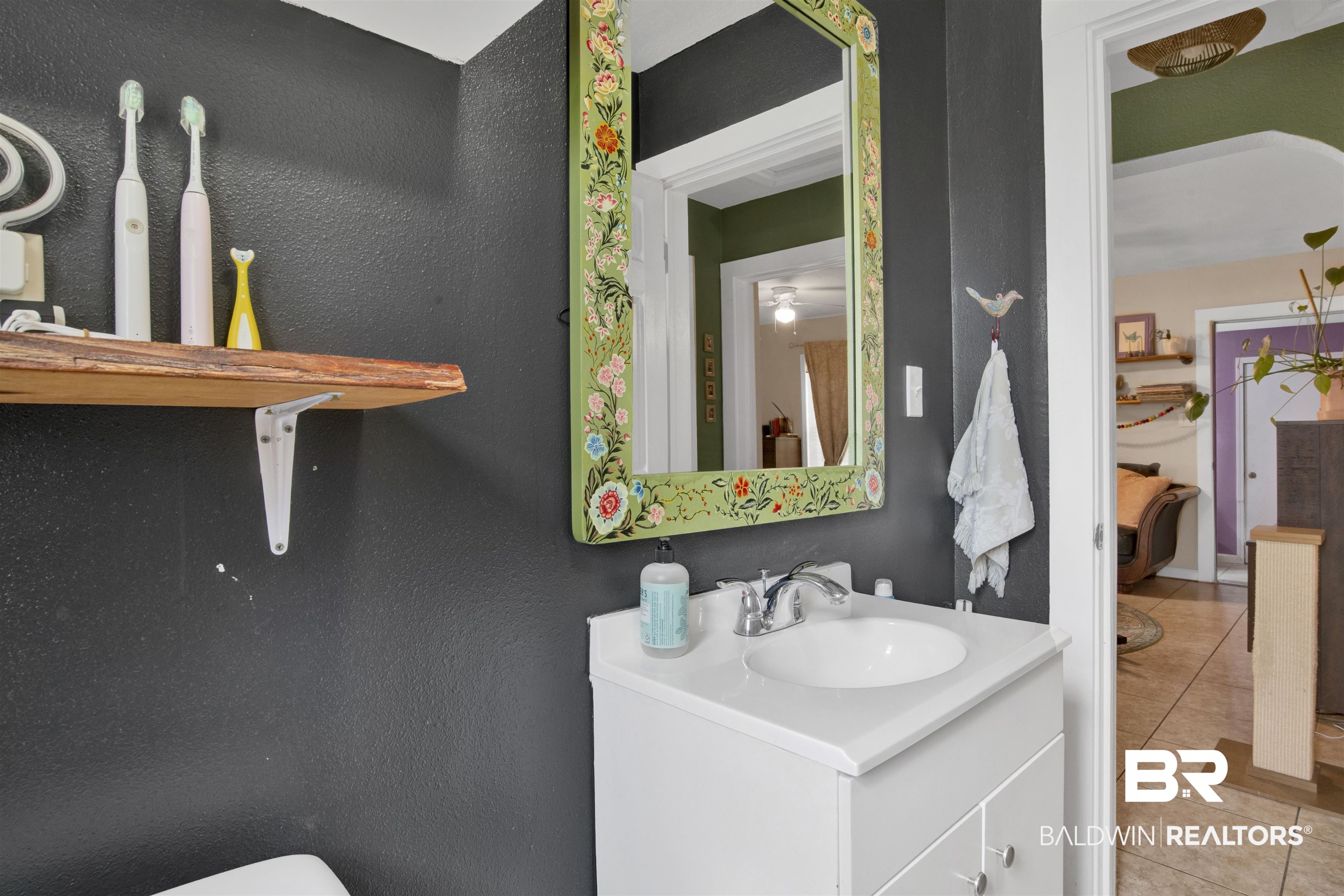 1100 North Pine Street Foley, AL 36535 - Photo 15 of 30 Bathroom vanity featuring a white cabinet with brushed nickel hardware, an integrated white sink, and a chrome faucet