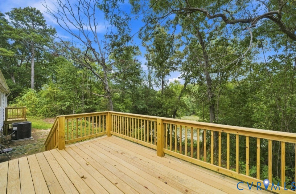 977 Burchs Mill Road Urbanna, VA 23175 - Photo 4 of 38 Large new wood deck with natural wood railing, off