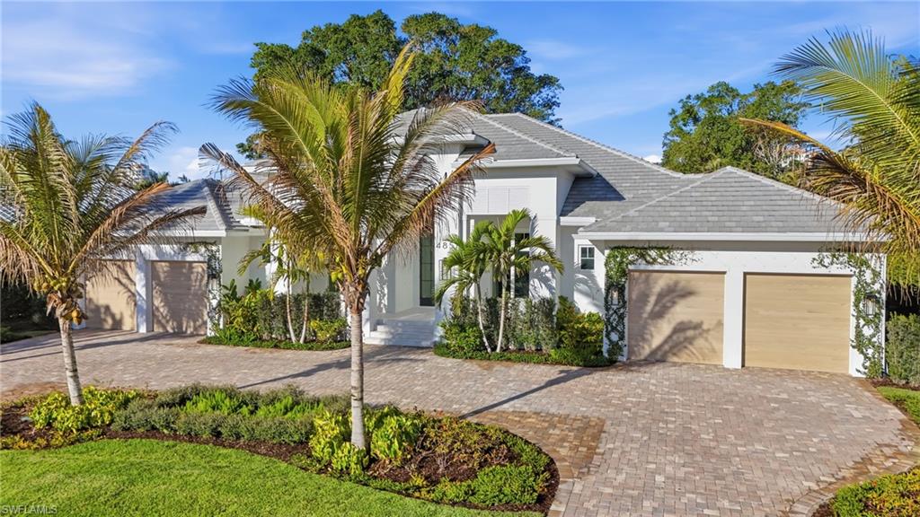 4851 Crayton Road Naples, FL 34103 - Photo 33 of 33 a front view of a house with garden