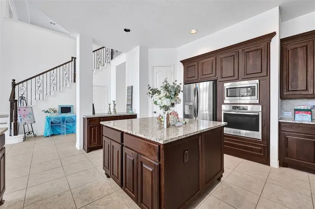 a dining room with furniture a chandelier and wooden floor