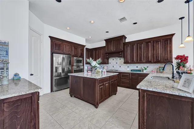 a kitchen with a stove sink and cabinets