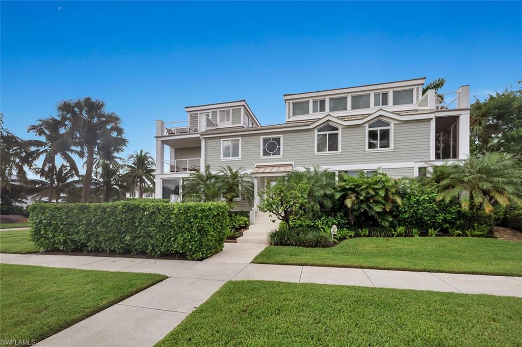 180 6th Avenue South, Unit 3 Naples, FL 34102 - Photo 1 of 44 a front view of a house with a yard