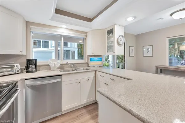 a kitchen with a sink and large window