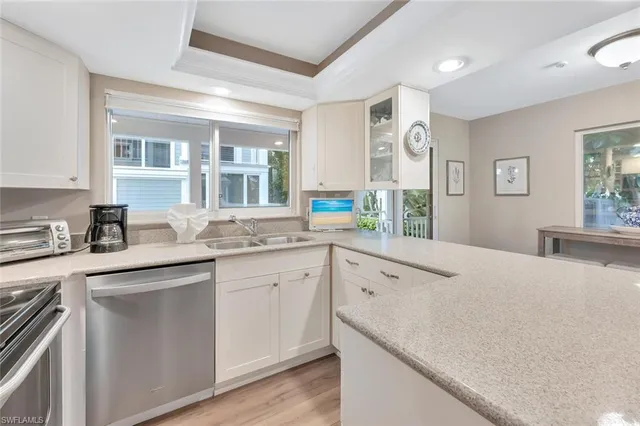 a kitchen with a sink and large window