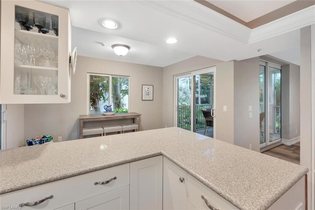 180 6th Avenue South, Unit 3 Naples, FL 34102 - Photo 14 of 44 a kitchen with a sink and large window