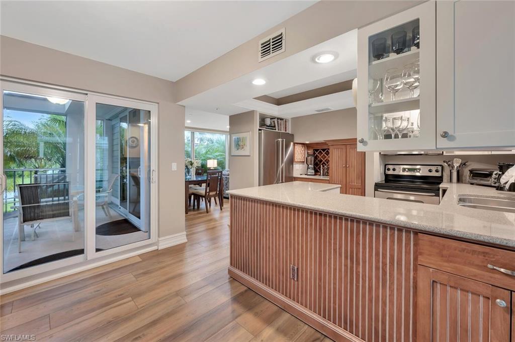 180 6th Avenue South, Unit 3 Naples, FL 34102 - Photo 15 of 44 a kitchen with stainless steel appliances granite countertop a stove and a sink