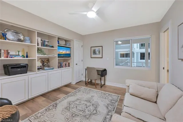 a living room with furniture and a book shelf