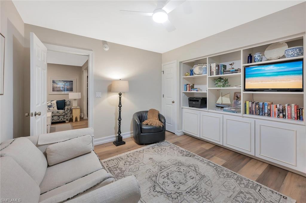 180 6th Avenue South, Unit 3 Naples, FL 34102 - Photo 19 of 44 a living room with furniture and a book shelf