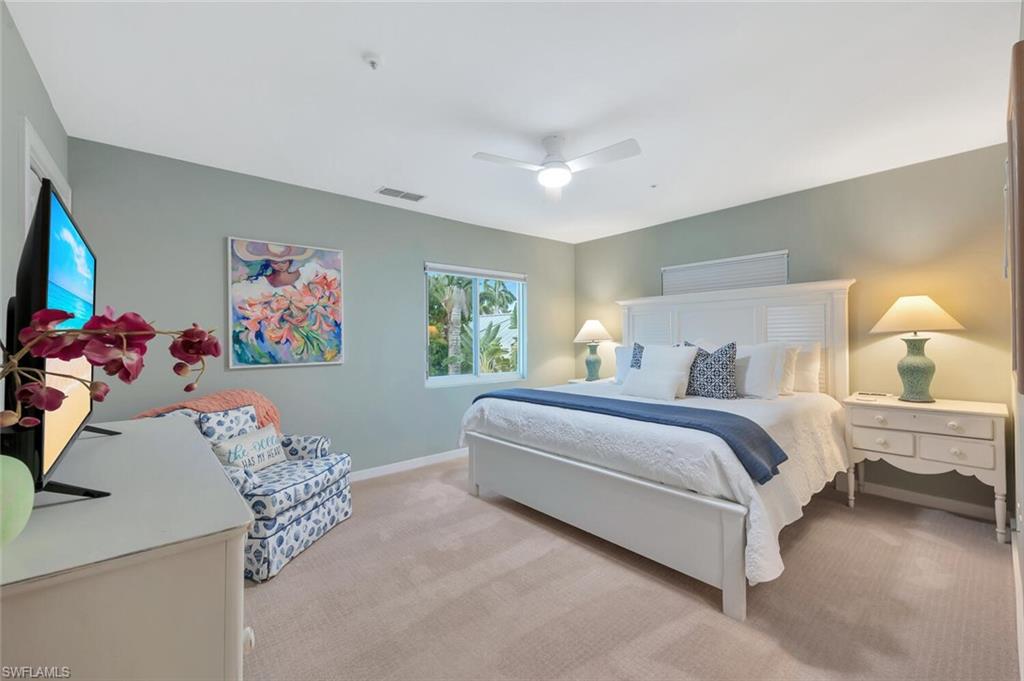 180 6th Avenue South, Unit 3 Naples, FL 34102 - Photo 22 of 44 a bedroom with bed and a couch