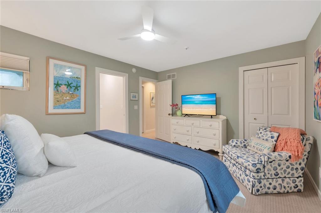 180 6th Avenue South, Unit 3 Naples, FL 34102 - Photo 23 of 44 a bedroom with a bed and a couch