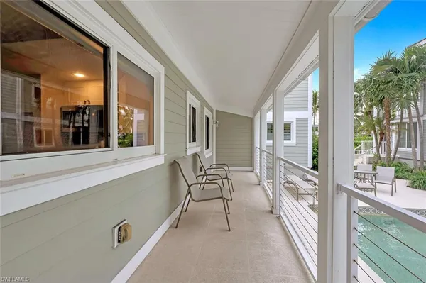 a view of porch with a bench and floor to ceiling windows