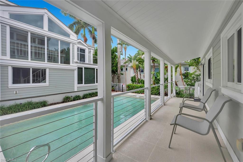 180 6th Avenue South, Unit 3 Naples, FL 34102 - Photo 27 of 44 a view of porch with a bench and floor to ceiling windows