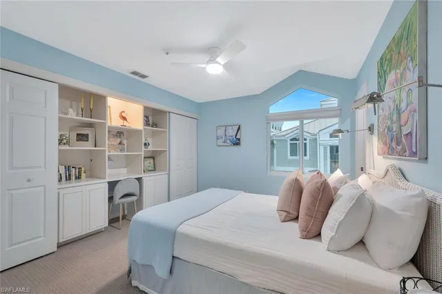 a bedroom with a large bed and a window