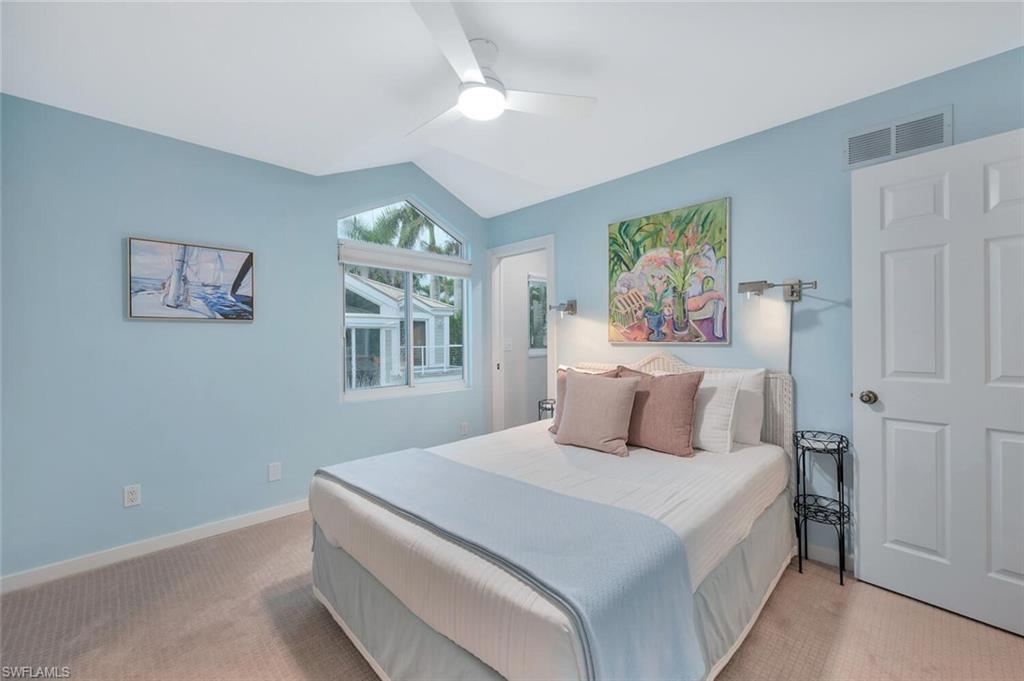 180 6th Avenue South, Unit 3 Naples, FL 34102 - Photo 29 of 44 a bedroom with a large bed and a window