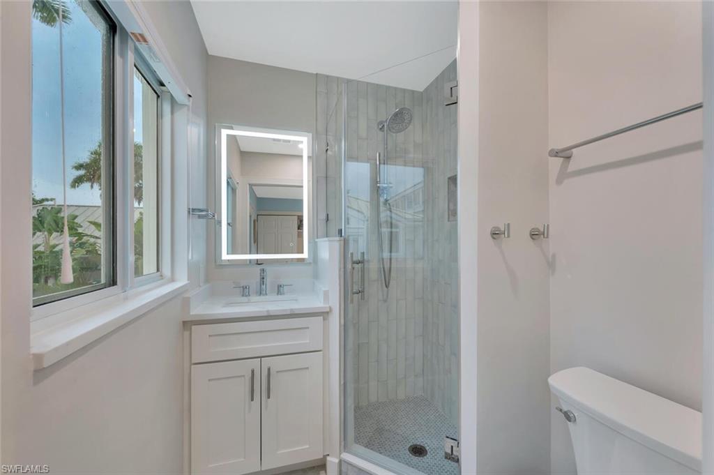 180 6th Avenue South, Unit 3 Naples, FL 34102 - Photo 30 of 44 a bathroom with a granite countertop sink toilet and shower