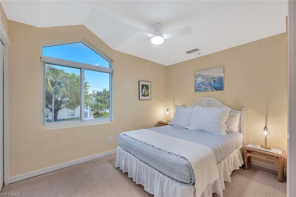 180 6th Avenue South, Unit 3 Naples, FL 34102 - Photo 31 of 44 a bedroom with a bed and a window