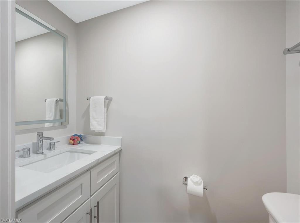 180 6th Avenue South, Unit 3 Naples, FL 34102 - Photo 32 of 44 a bathroom with a sink vanity and a mirror