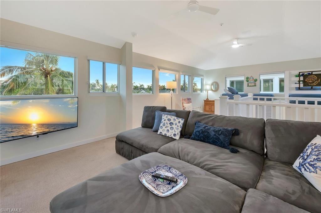 180 6th Avenue South, Unit 3 Naples, FL 34102 - Photo 34 of 44 a living room with furniture and a flat screen tv