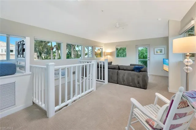 a living room with furniture and baby crib