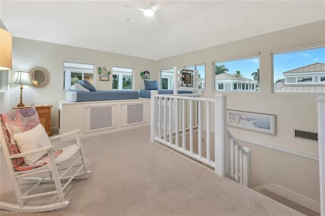 a view of a chair and tables in the balcony