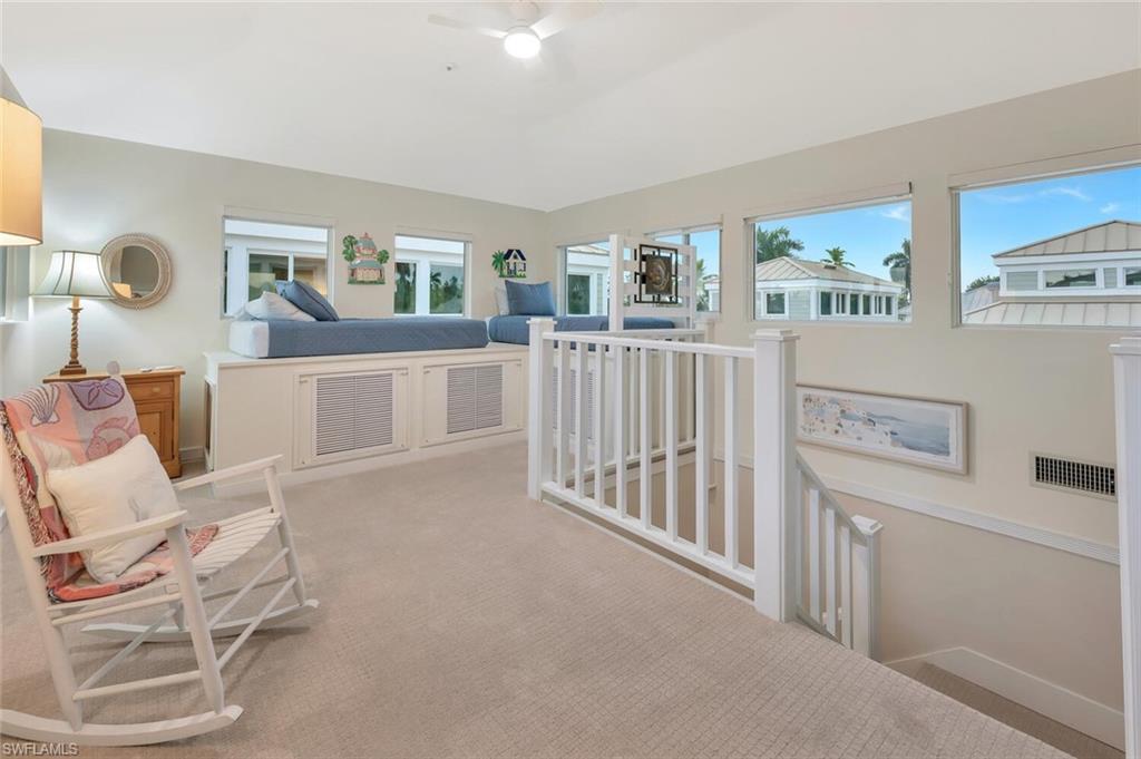 180 6th Avenue South, Unit 3 Naples, FL 34102 - Photo 36 of 44 a living room with furniture and baby crib
