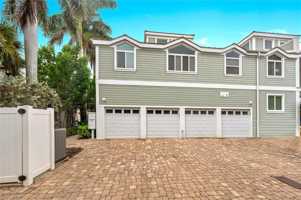 180 6th Avenue South, Unit 3 Naples, FL 34102 - Photo 42 of 44 a front view of a house with a yard