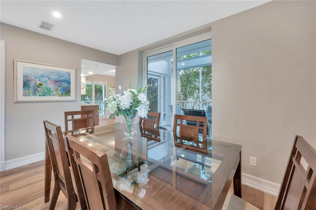 180 6th Avenue South, Unit 3 Naples, FL 34102 - Photo 8 of 44 a view of a dining room with furniture window and wooden floor