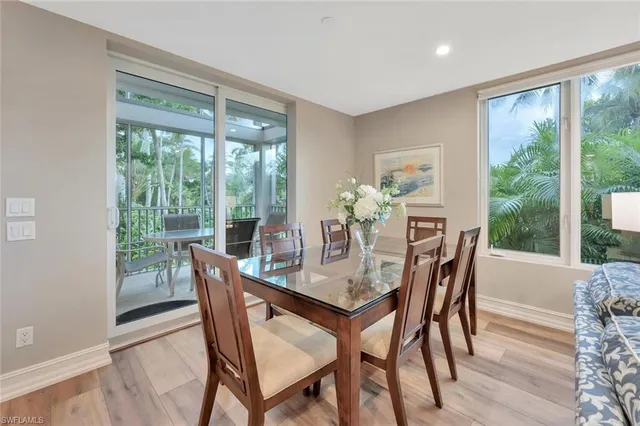 a dining room with furniture window and wooden floor