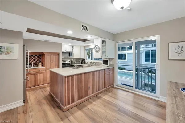 a view of a kitchen with kitchen island a large window