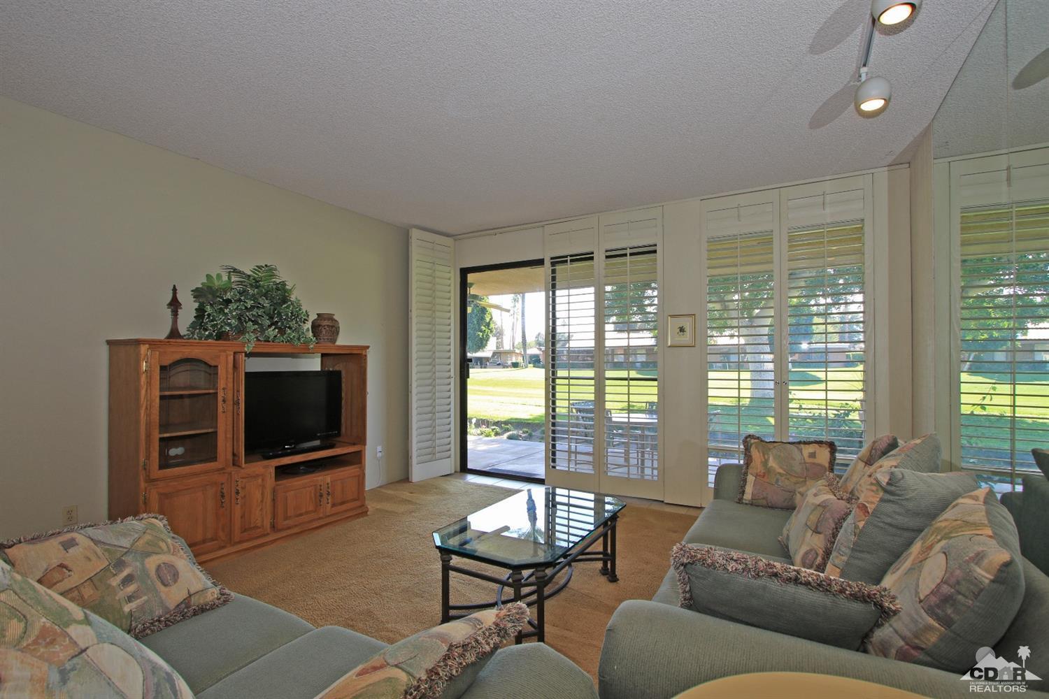 7 Palma Drive Rancho Mirage, CA 92270 - Photo 11 of 33 a living room with furniture and a flat screen tv