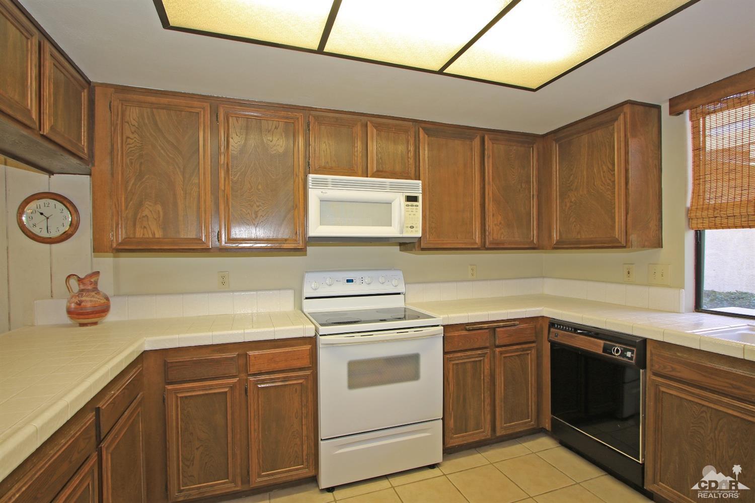 7 Palma Drive Rancho Mirage, CA 92270 - Photo 12 of 33 a kitchen with a sink stove and cabinets