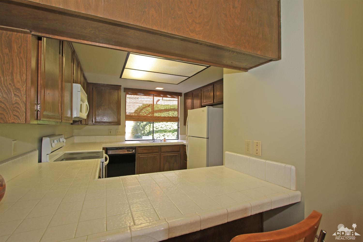 7 Palma Drive Rancho Mirage, CA 92270 - Photo 15 of 33 a kitchen with a sink and large window