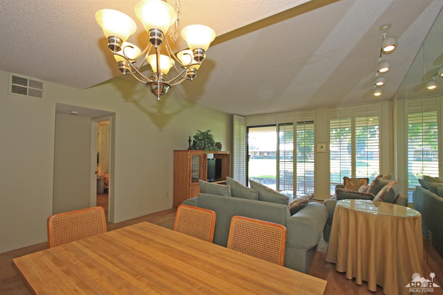 7 Palma Drive Rancho Mirage, CA 92270 - Photo 18 of 33 a bedroom with a large bed and a chandelier