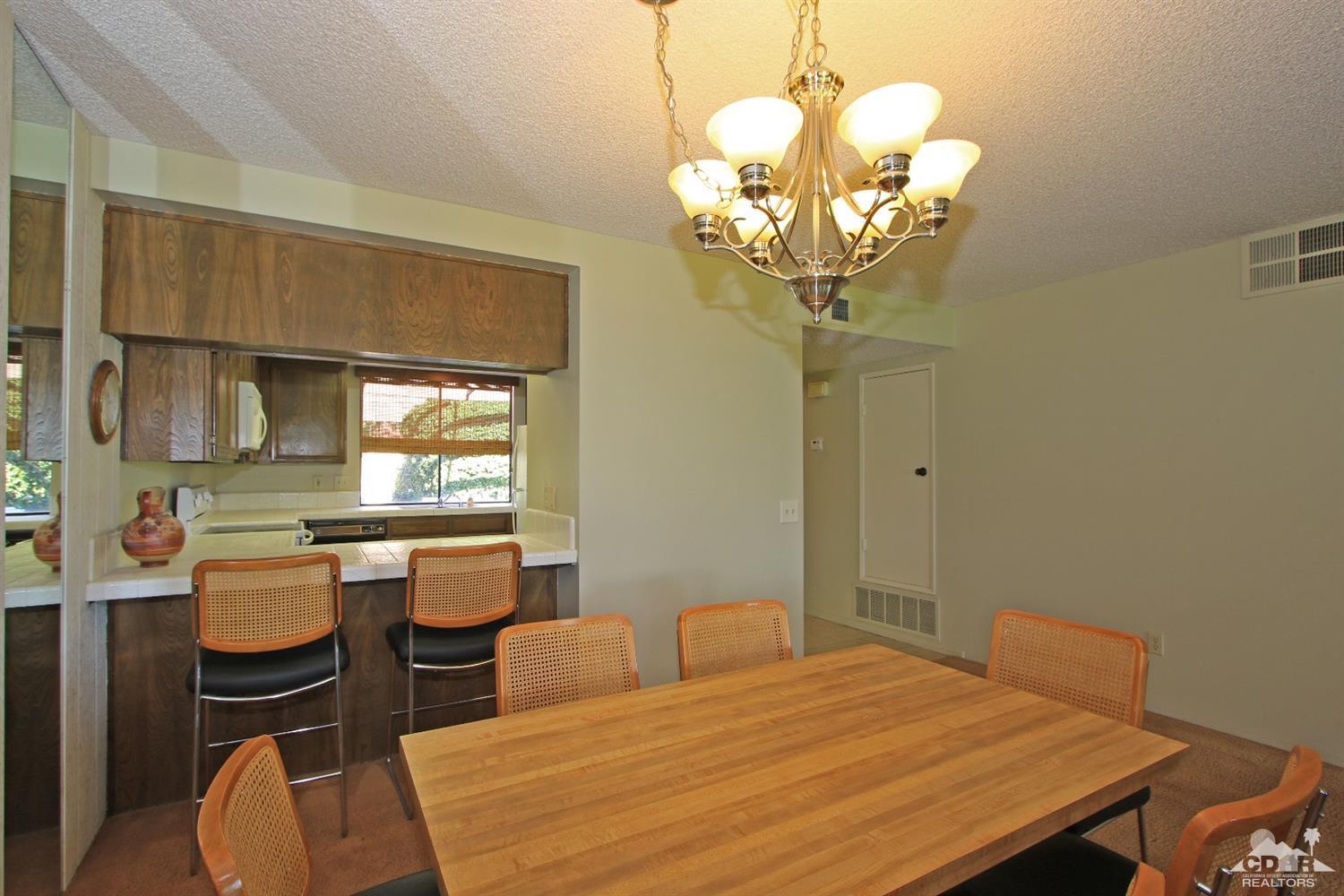 7 Palma Drive Rancho Mirage, CA 92270 - Photo 19 of 33 a bedroom with a bed and a chandelier