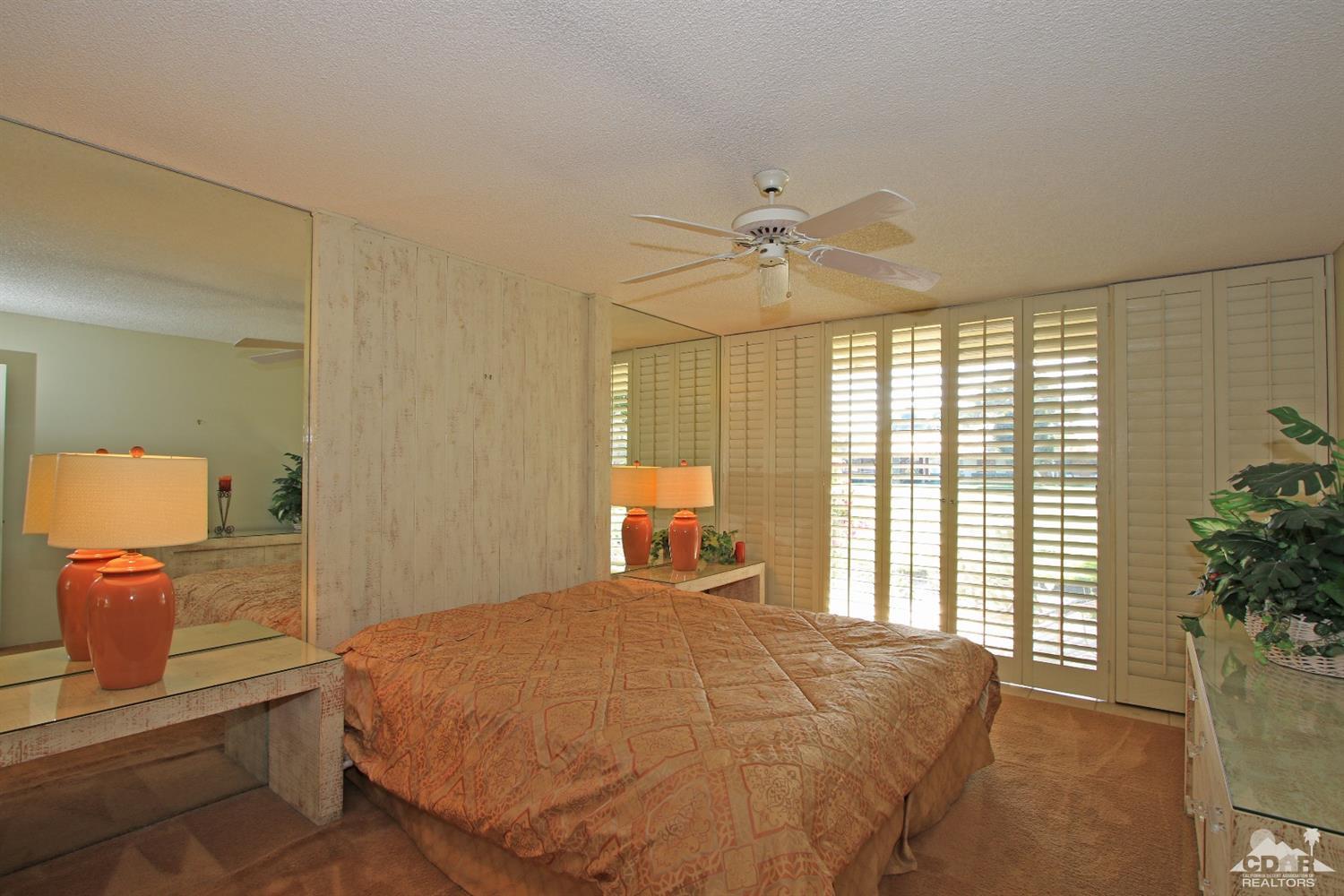 7 Palma Drive Rancho Mirage, CA 92270 - Photo 20 of 33 a bedroom with a large bed and a large window