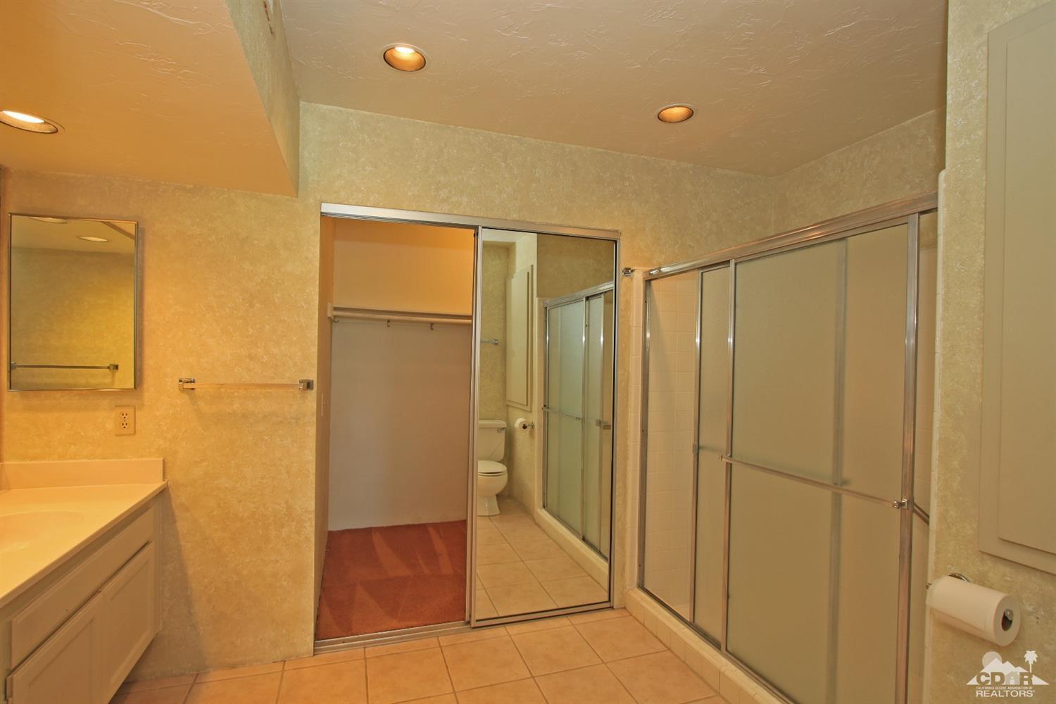 7 Palma Drive Rancho Mirage, CA 92270 - Photo 23 of 33 a bathroom with a shower and a glass door