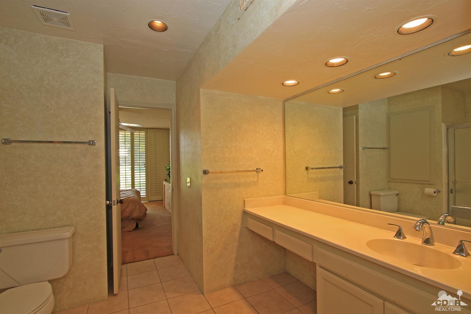 7 Palma Drive Rancho Mirage, CA 92270 - Photo 24 of 33 a bathroom with a double vanity sink toilet and shower