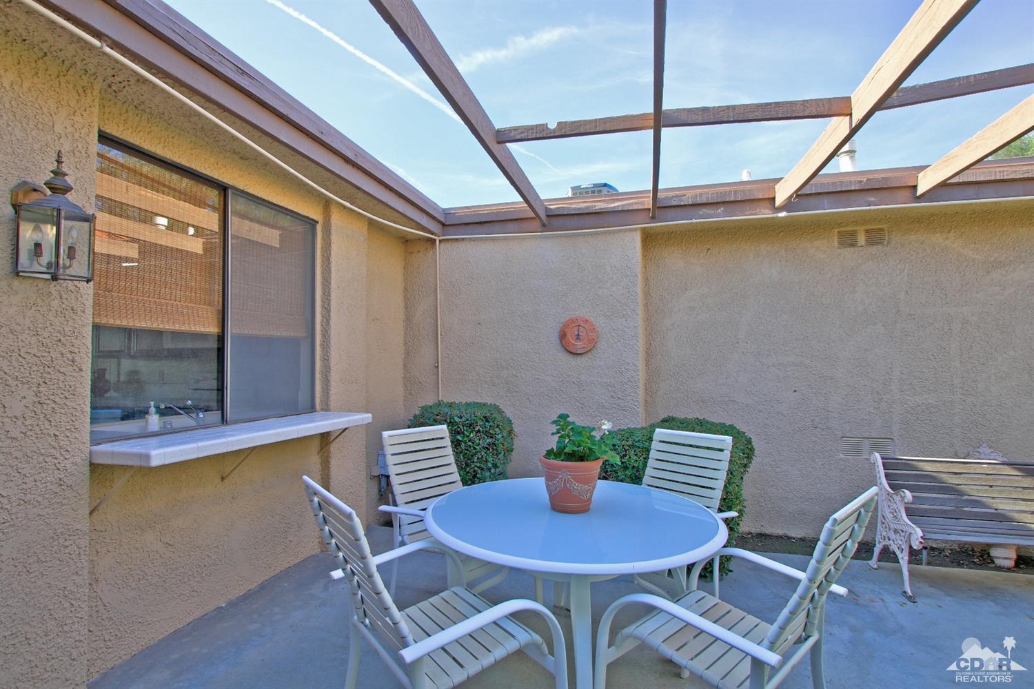 7 Palma Drive Rancho Mirage, CA 92270 - Photo 33 of 33 a view of a dining room with furniture and wooden floor