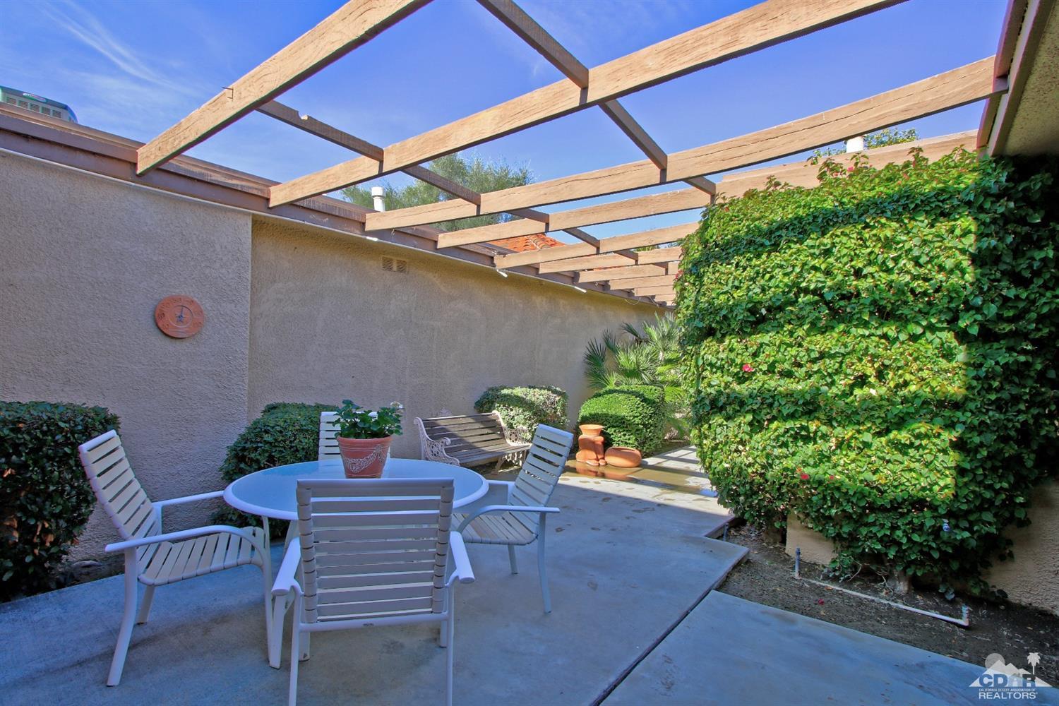 7 Palma Drive Rancho Mirage, CA 92270 - Photo 6 of 33 a backyard of a house with table and chairs plants
