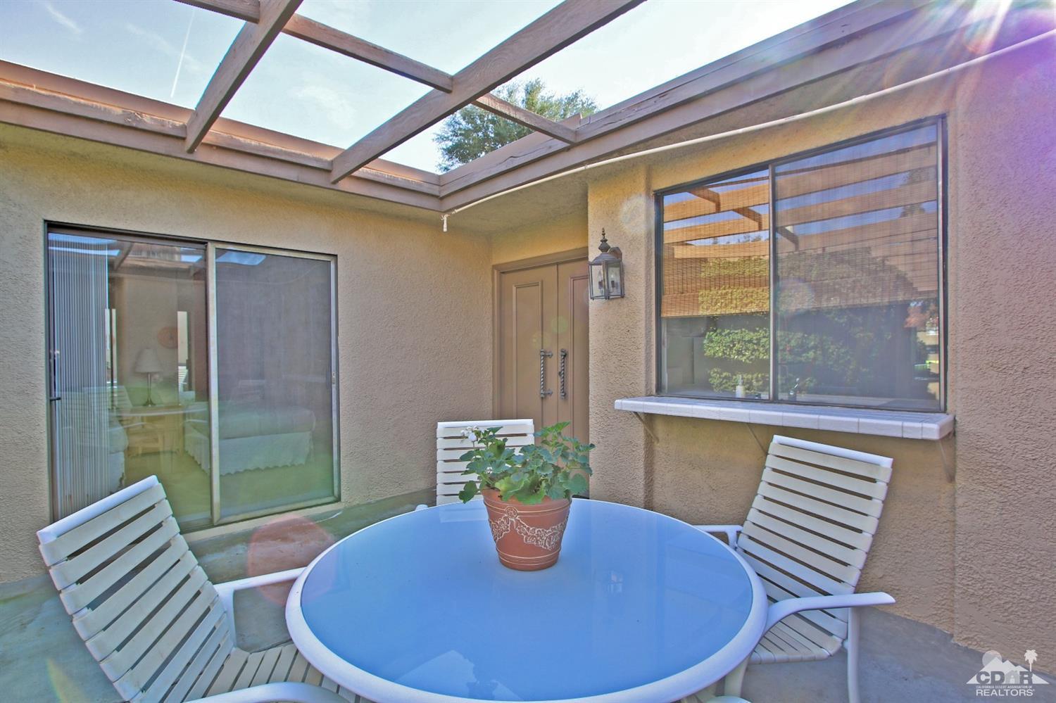 7 Palma Drive Rancho Mirage, CA 92270 - Photo 7 of 33 a view of a dining room with furniture window and wooden floor