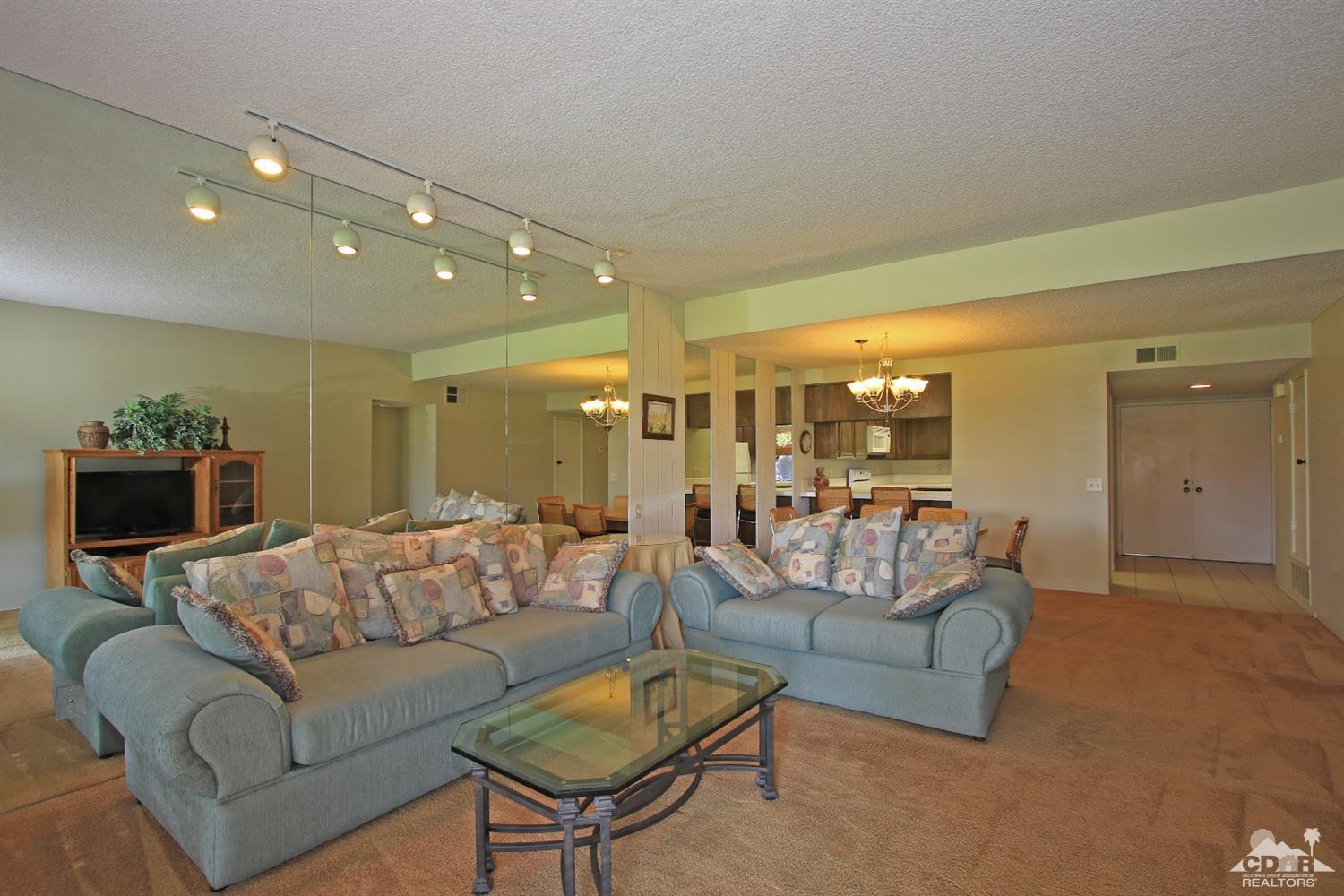 7 Palma Drive Rancho Mirage, CA 92270 - Photo 8 of 33 a living room with furniture and a chandelier