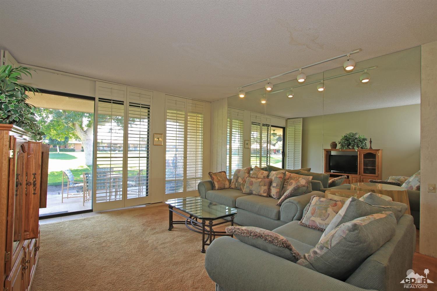 7 Palma Drive Rancho Mirage, CA 92270 - Photo 10 of 33 a living room with furniture and a large window