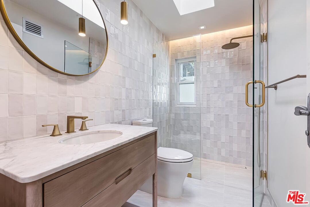 2203 Bowmont Drive Beverly Hills, CA 90210 - Photo 19 of 21 a bathroom with a sink a toilet and shower