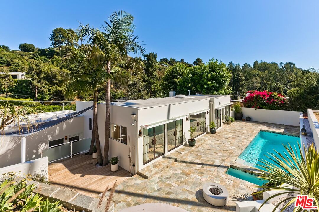 2203 Bowmont Drive Beverly Hills, CA 90210 - Photo 21 of 21 a view of a patio with table and chairs and potted plants