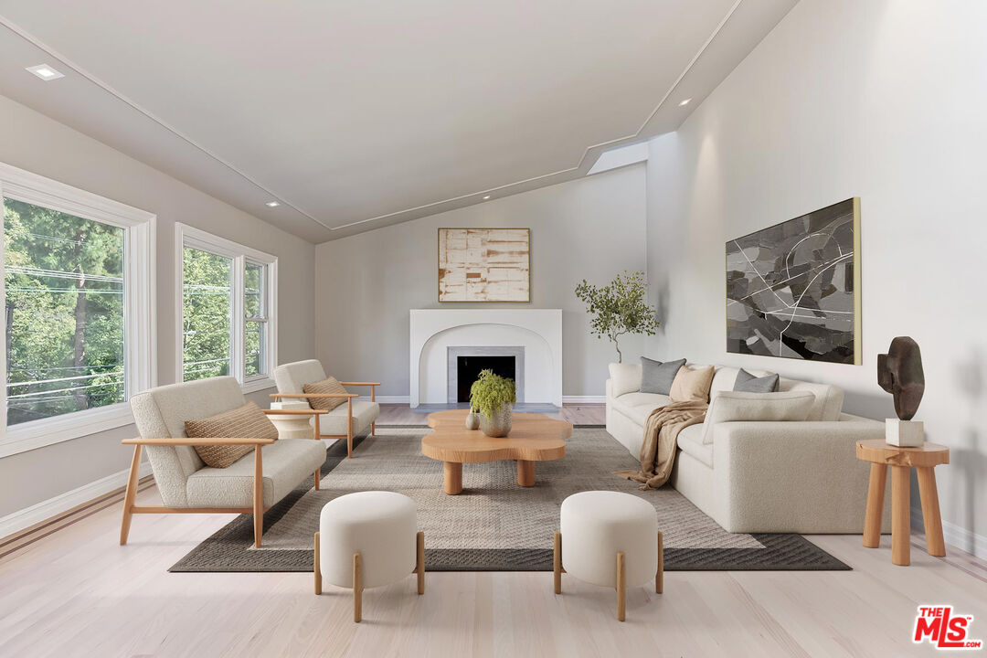 2203 Bowmont Drive Beverly Hills, CA 90210 - Photo 3 of 21 a living room with furniture a fireplace and a large window