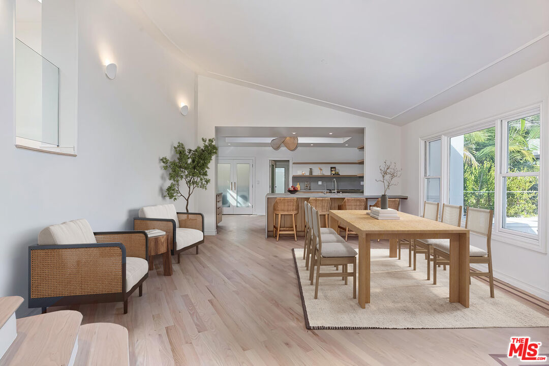 2203 Bowmont Drive Beverly Hills, CA 90210 - Photo 6 of 21 a living room with furniture a rug potted plant and a large window
