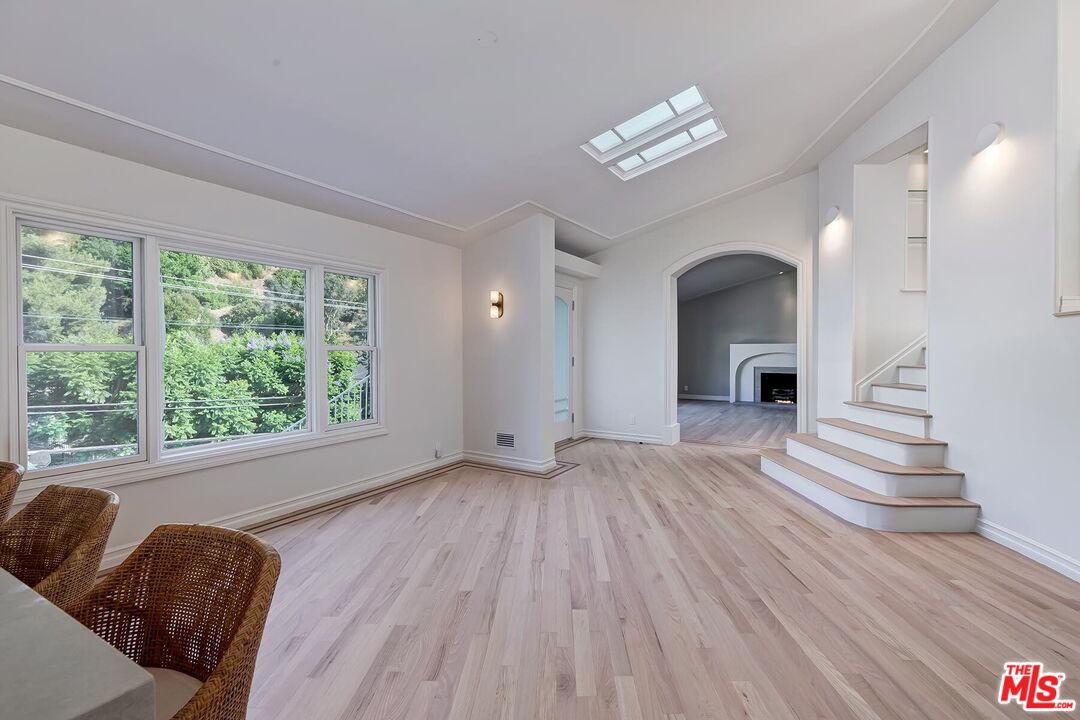 2203 Bowmont Drive Beverly Hills, CA 90210 - Photo 7 of 21 a view of a livingroom with wooden floor and a large window