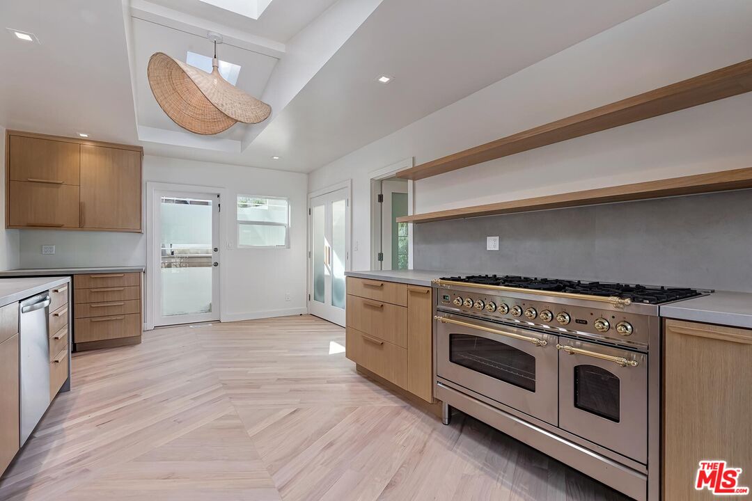 2203 Bowmont Drive Beverly Hills, CA 90210 - Photo 9 of 21 a kitchen with a stove oven and sink