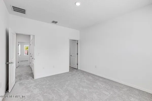 a bedroom with a bed and a mirror